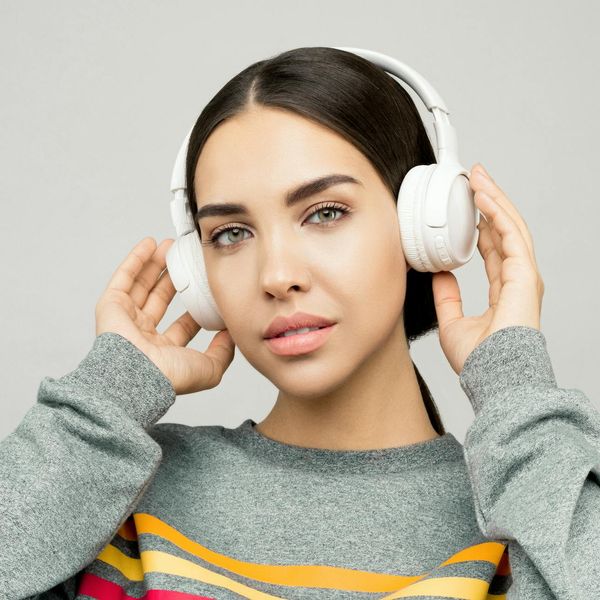 A serene woman with eyes closed, focusing calmly.